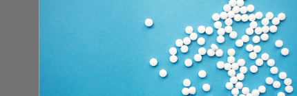 little white pills on blue background